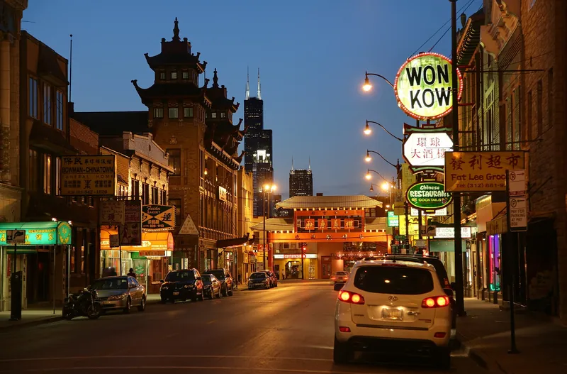 Wentworth Avenue in Chinatown at dusk with neon restaurant signs