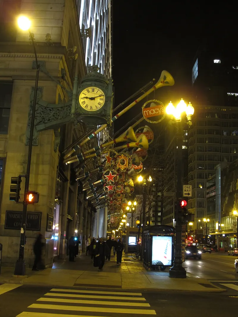 The green Marshall Field's clock at night with holiday decorations